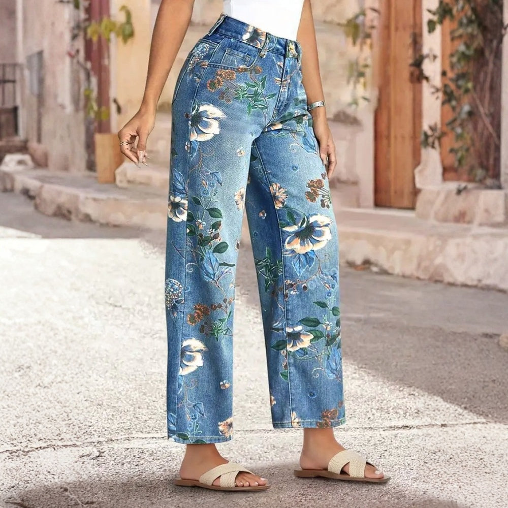 Person wearing floral-patterned blue jeans on a street.