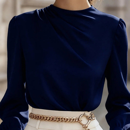 Navy blue long-sleeve top worn by a person with a blurred background