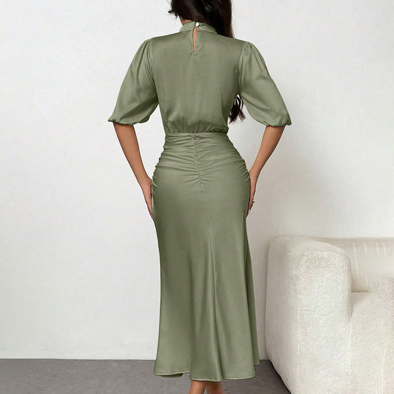 Woman wearing a green dress against a white background