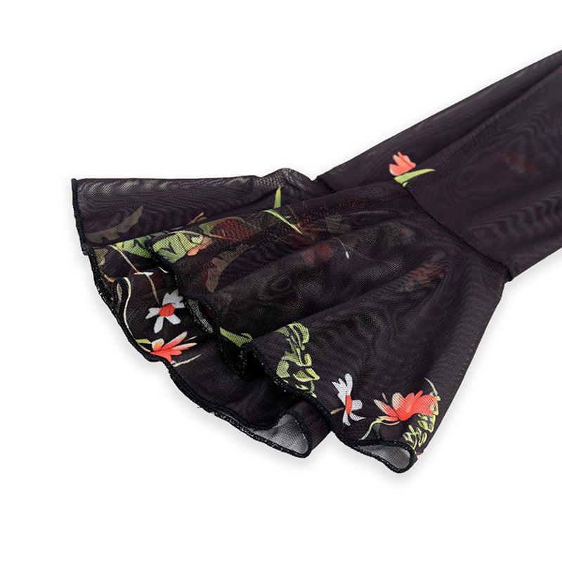 Black sheer fabric with floral embroidery on a white background