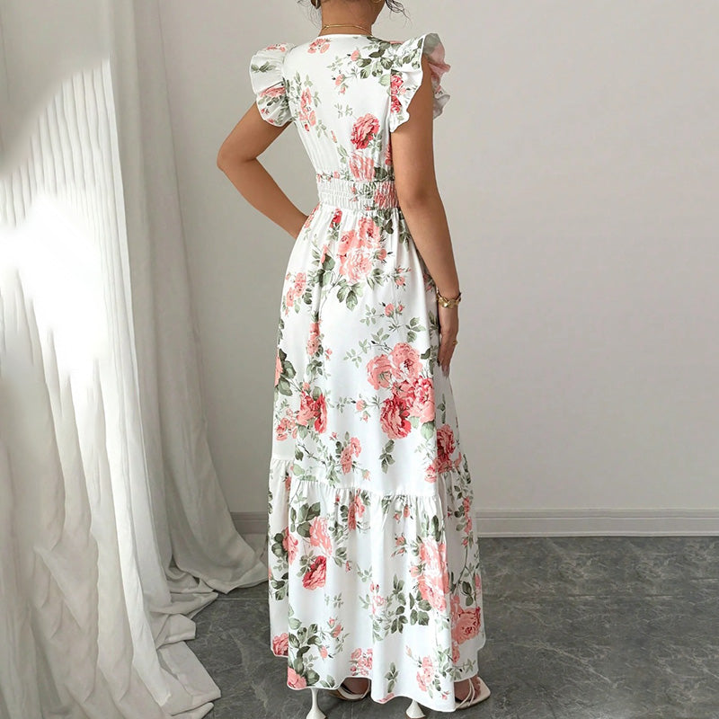 Woman wearing a floral dress in a minimal indoor setting