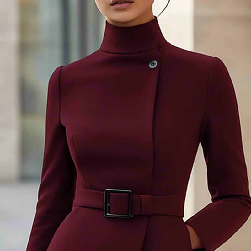Maroon dress with a belt and button detail on a blurred background