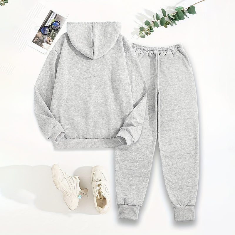 Gray hoodie and jogger pants set with white sneakers on a light background